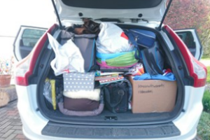 Unorganised boxes and personal belongings in car